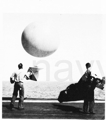 Radiosonde release USS Saratoga 1959 - AG3 Ken Overholt with shroud - AG2 Frank Belleau with transmi